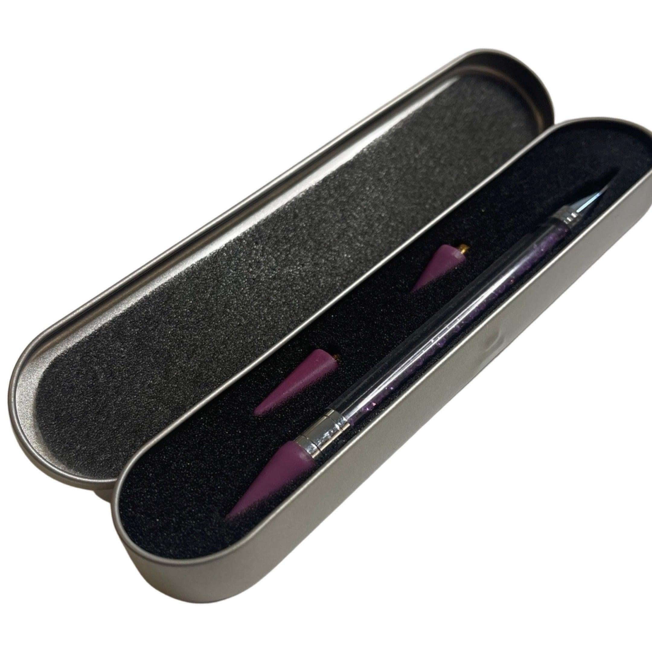 Dual tip jewel picker wax pen for rhinestones and nail art



Close-up of wax tip jewel picker tool



Jewel picker pen in use with rhinestones and gems